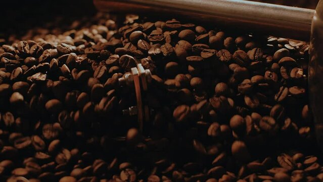 Fragrant coffee beans are roasted, hot aroma coffee seeds. Coffee production. Macro shot