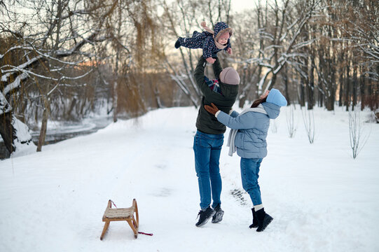 happy parents with their cute baby have a fun outdoor