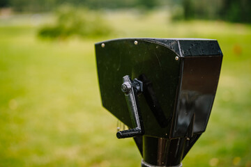 Sigulda, Latvia - July 30, 2023 - Close-up of a black ball washer on a golf course with water...