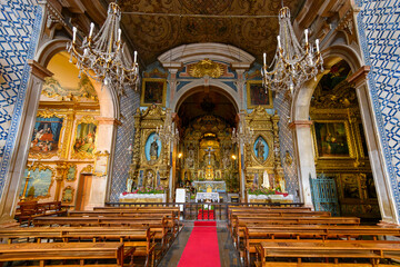 The ornate interior nave and chapel inside the 18th century St. Peter's Catholic Church, or Igreja de São Pedro, in the historic old town district of Funchal, Portugal, on the Canary Island of Madeira - obrazy, fototapety, plakaty
