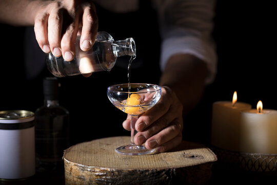 Bartender Pouring White Grappa From the Bottle