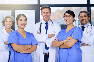 Teamwork, healthcare and portrait of doctors with crossed arms for medical service, insurance or collaboration. Professional, hospital and men and women in clinic for wellness, medicare or consulting