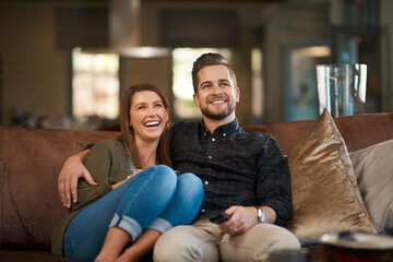 Happy couple, smile and hug on sofa for movie, care or in love for relationship and dating on...