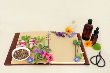 Herbal medicine preparation with flowers and herbs for natural aromatherapy treatments. Ingredients for alternative remedies with recipe notebook, essence bottles on hemp paper. - 789620680