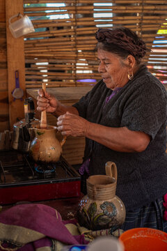 Senior woman making Atole
