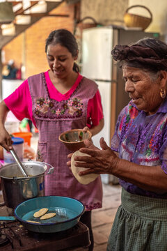 Mother and daughter cooking mexican food
