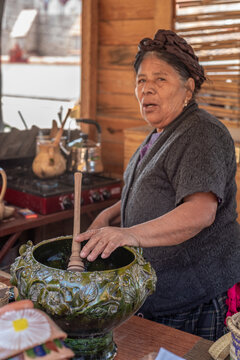 Senior woman making Atole