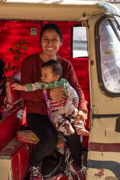 Mexican mother with baby on car