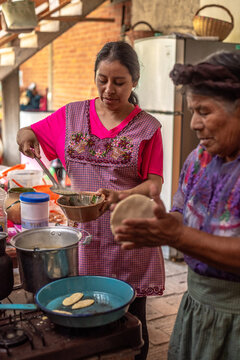 Mother and daughter cooking together
