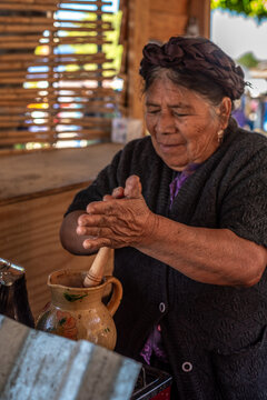 Senior woman making Atole