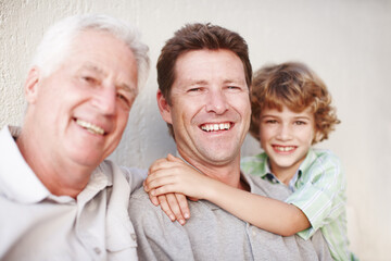Hug, portrait and kid with father, grandfather and laughter by a house with care, trust and support. Happy family, bonding and male generations by a wall for weekend, vacation or reunion at home