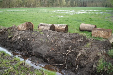 Drainage pipes clogged with mud and soil. Due to constant rainfall and a totally muddy environment, the concrete pipes have become clogged with soil and need to be replaced. Resse Wedemark, Germany.