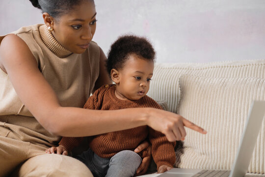 Interactive Learning: Mother and Baby with laptop at home