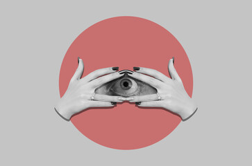 Eye looking trough fingers of a female hands