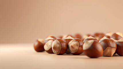 Hazelnuts in their shells. A close-up of a handful of hazelnuts. The nuts are brown and have a rough texture. - obrazy, fototapety, plakaty