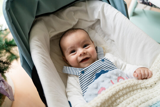 Infant Smiling Joyfully in Stroller