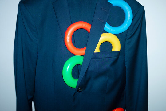 Conceptual photo of office business style suit with colourful rings