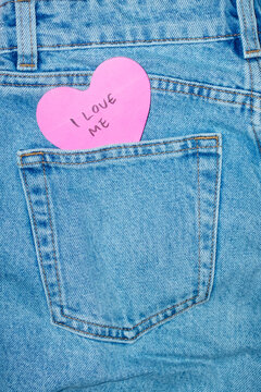 Classic blue jeans with heart-shaped post it note and "I love me" text