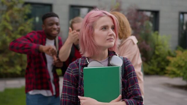 Sad stressed scared offended school girl student woman informal hipster with pink hair suffer aggressive multiracial students classmates mock abused humiliate bully mockery bullying university racism