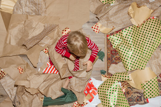 Child With Christmas Wrapping Paper