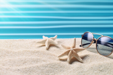 Fototapeta na wymiar Frame from seashell starfish and beach sand on blue wooden background. Summer holiday banner. Sunglasses in center.