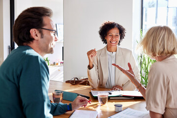 Happy couple discussing new project investments with financial advisor
