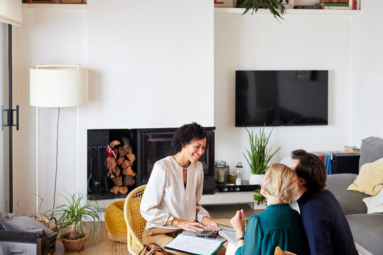 Happy agent discussing home finance with couple