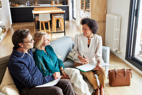Couple listening to financial advisor at home