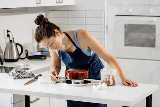 The girl prepares a chocolate glazed mousse