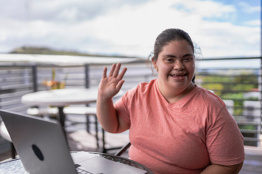 Person with down syndrome waving with his hand