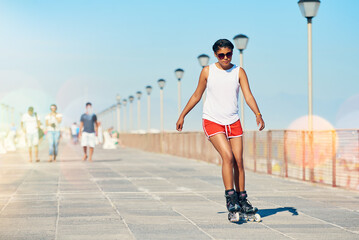 Woman, rollerskate and summer with hobby for active fitness or health for exercise. Training, fun and workout with lens flare for sport with cardio or leisure in sunshine for competition in Australia