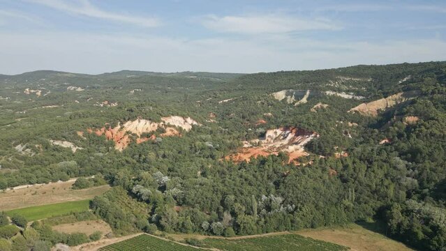Aerial footage of Red sands and abstract Rustrel canyon moher cliffs landscape. Provencal Colorado near Roussillon,in the Vaucluse department - Southern France.
