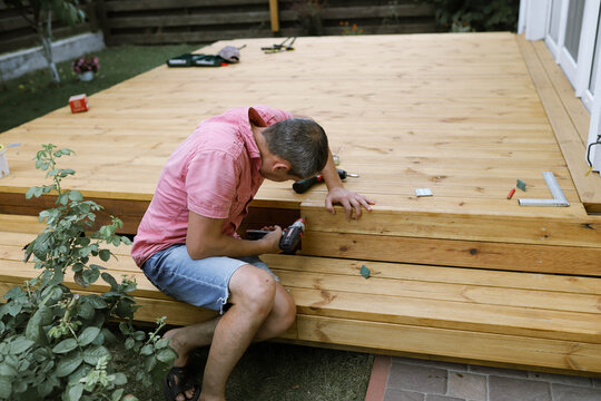 a man makes a terrace in the yard