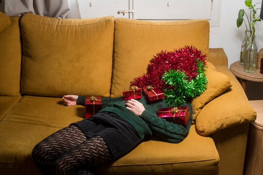 Woman covered with xmas gifts and decorations