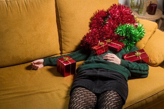 Woman covered with xmas ornaments and gifts