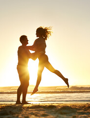 Lifting, sunset and couple with love at beach, ocean or sea for affection, bonding or for fun with...