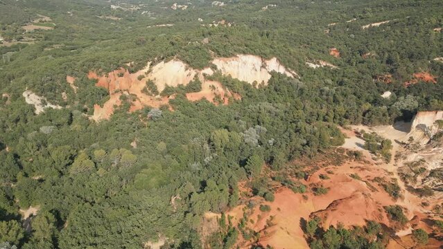 Aerial footage of Red sands and abstract Rustrel canyon moher cliffs landscape. Provencal Colorado near Roussillon,in the Vaucluse department - Southern France.