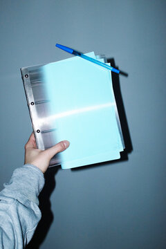 Business office folder and baby blue paper and pen and hard flashlight