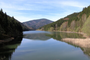 Bay of the Sance dam reservoir in the Beskydy Mountains in the Czech Republic. Sunny spring day.