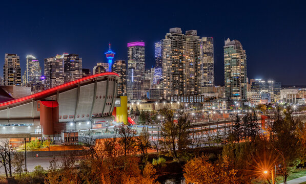 Calgary, Alberta, Canada, October 7, 2023: Calgary's downtown at night with the Scotiabank Saddledome. The dome is home to the Calgary Flames NHL club and is nearing the end of its useful lifespan.