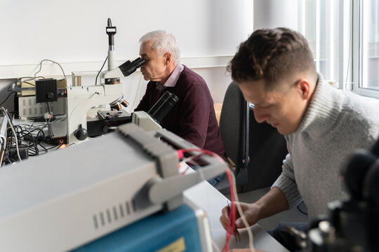 Close Up Of People Working In Lab 
