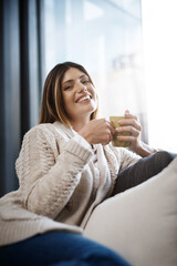 Woman, home and happy with coffee to relax on day off and leisure. Female person, sofa and smile in...