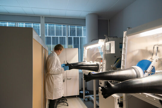 Male Scientist Using  Glovebox