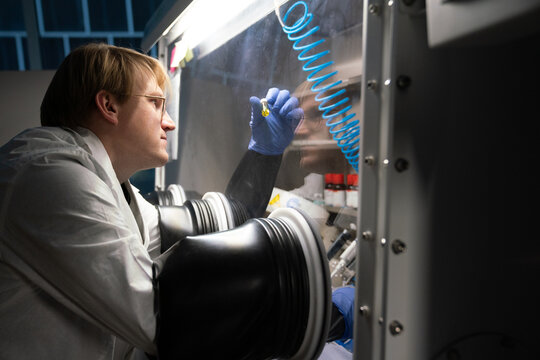 Male Researcher Using The Glovebox