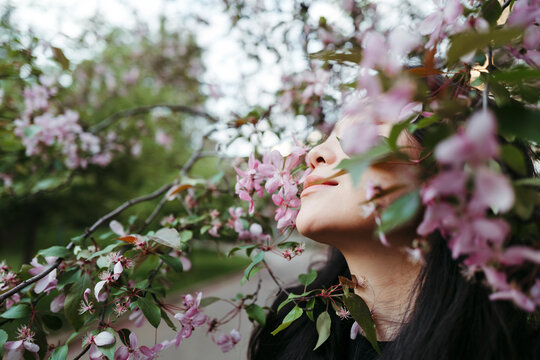 Young Serene famale in blooming garden.