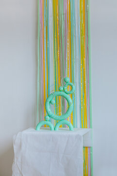 Green colored torus with with sparkles, beads on a coloured background