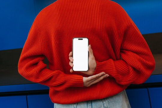 A mobile phone with white screen in woman's hand