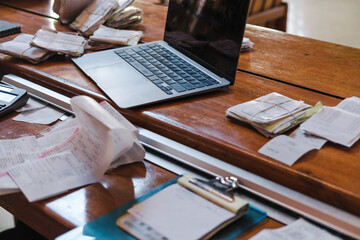 messy receipts and a  laptop