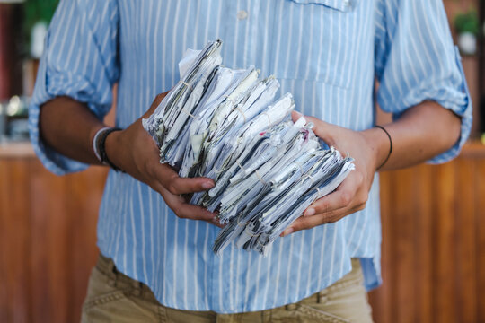 person holding a bunch of receipts 