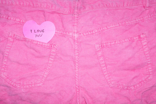 Pink jeans with heart-shaped post it note & "I love you" text